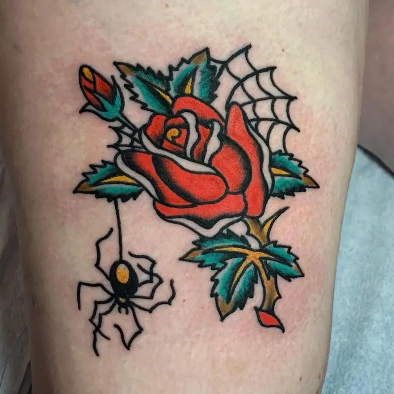 a rose tattoo with a spider