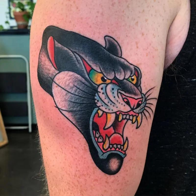 a tattoo of a panther on a person's arm