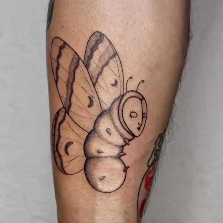 a tattoo of a caterpillar on a person's leg