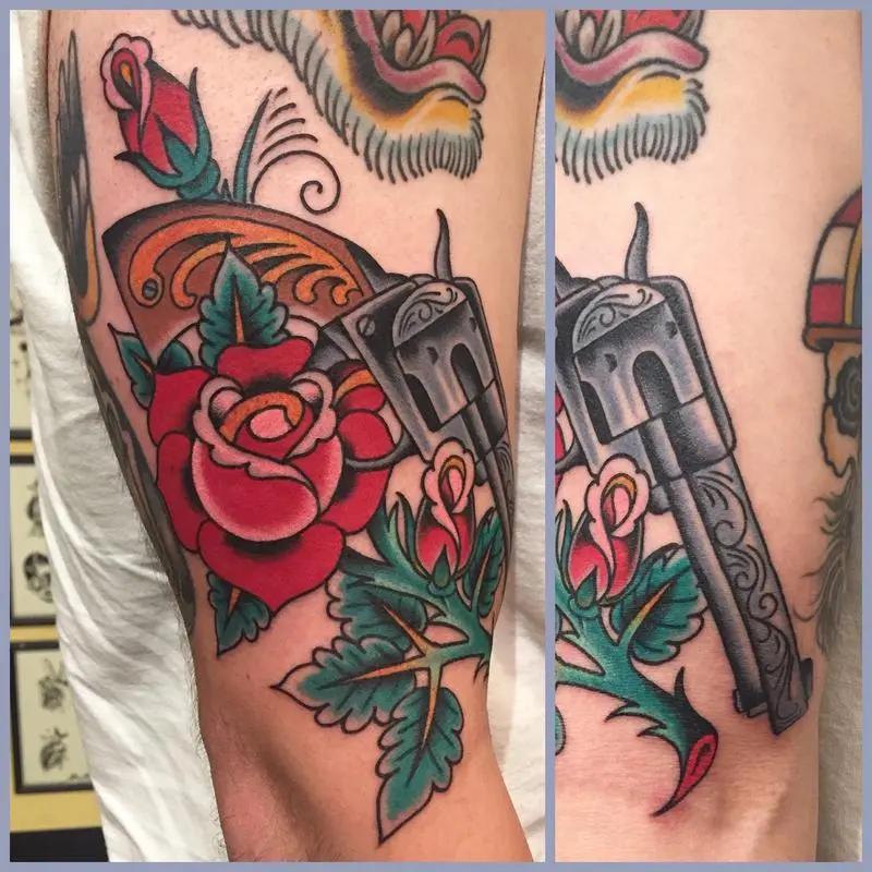 a tattoo of a  gun and roses