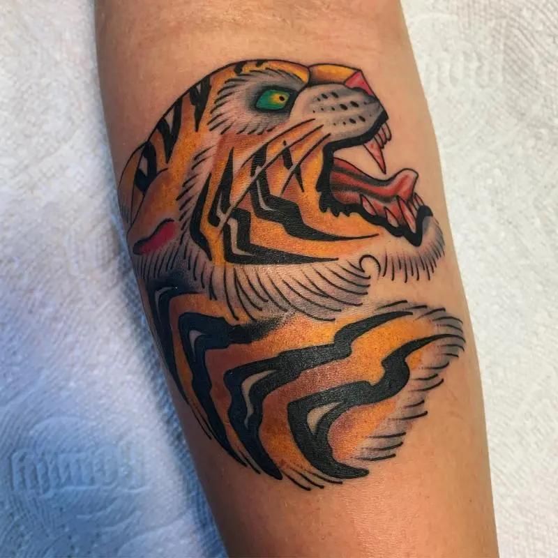 a tattoo of a tiger on a person's arm