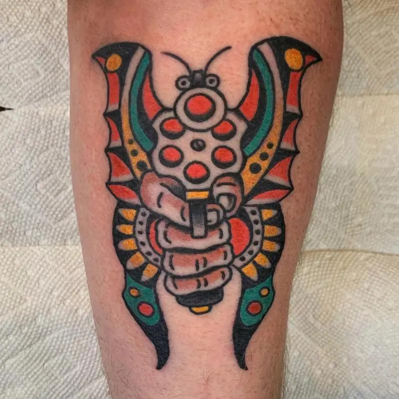 an abstract gun and butterfly tattoo