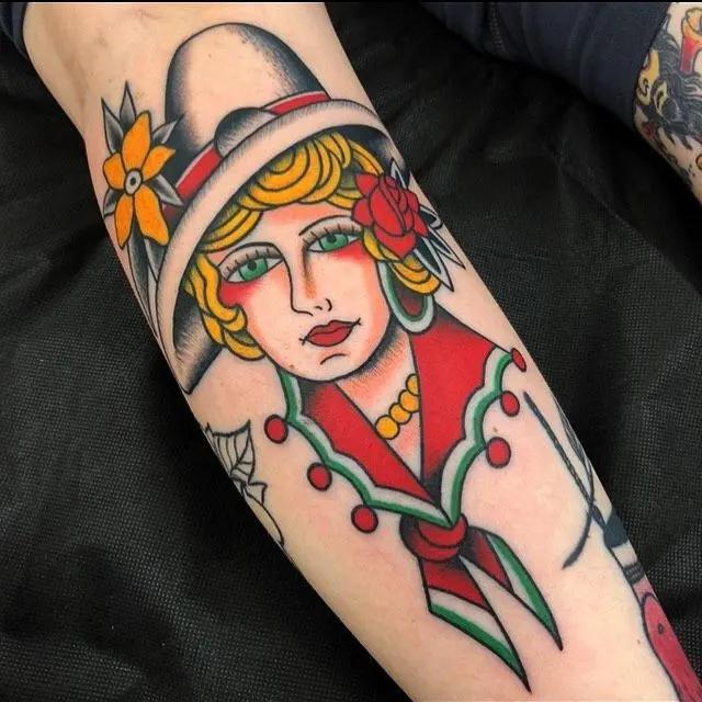 a woman wearing a hat tattoo