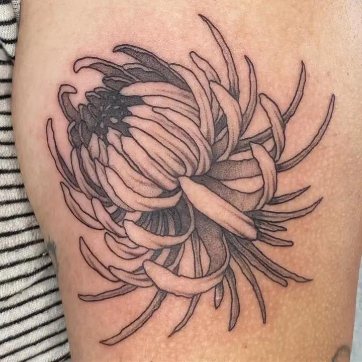 a tattoo of a flower on a person's arm