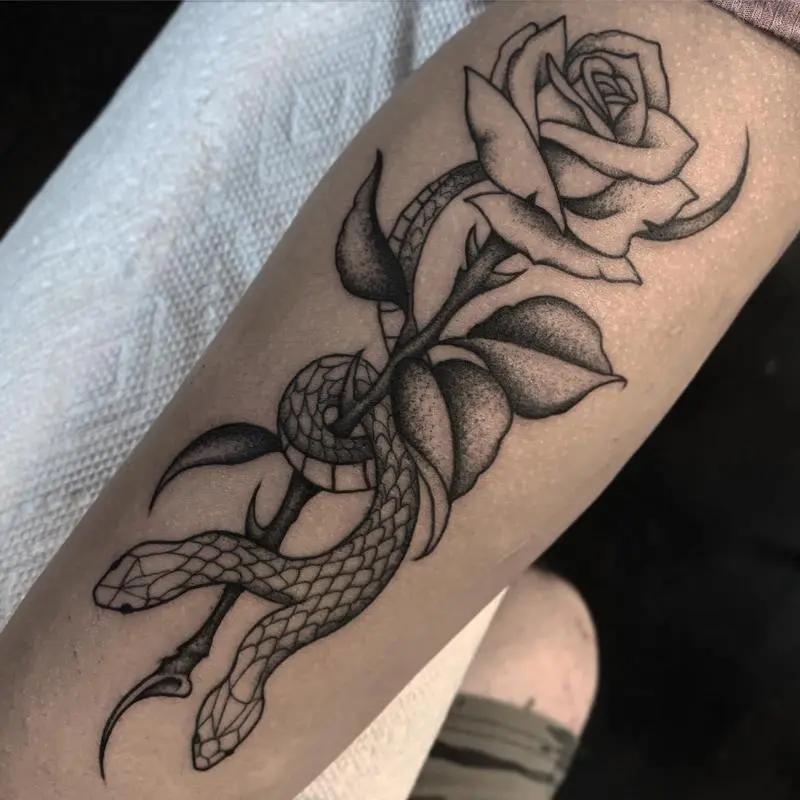 a tattoo of a rose on a person's arm