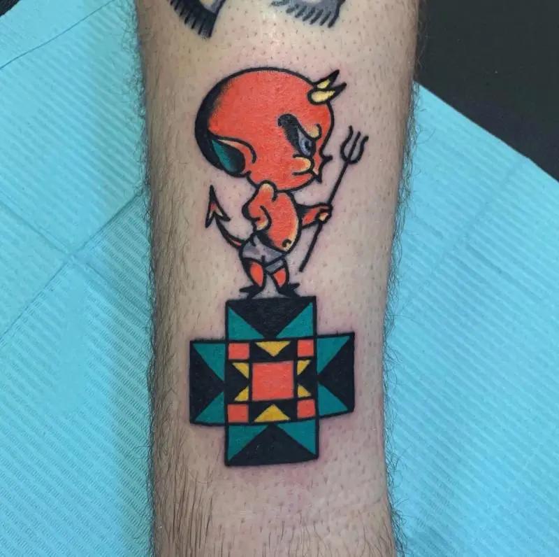 a devil tattoo holding a trident