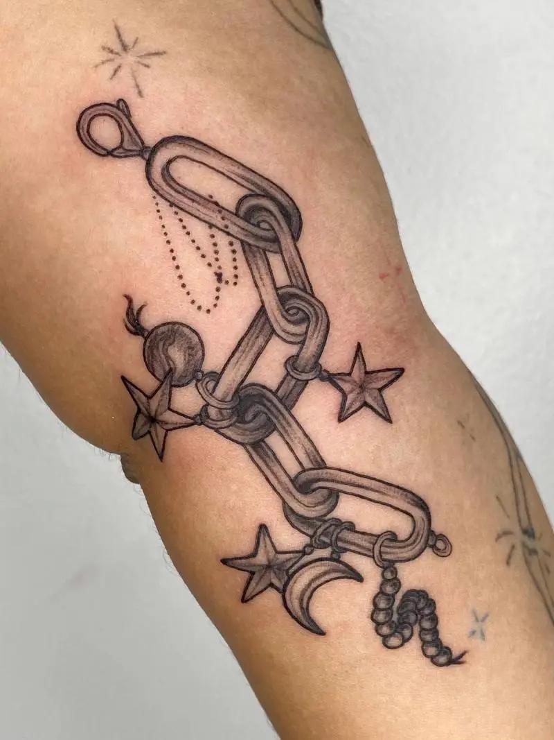 a tattoo of a chain on a person's arm