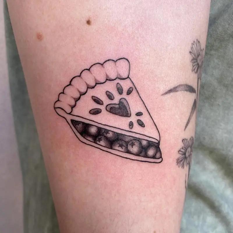 a tattoo of pizza in a person's arm