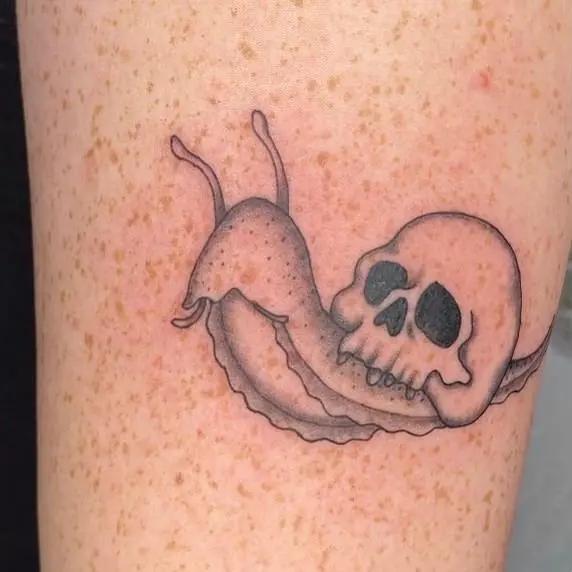 a tattoo of a skull on a person's arm