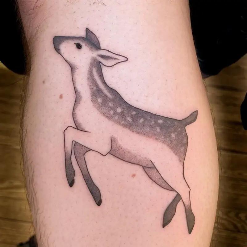 a tattoo of a deer on a person's arm