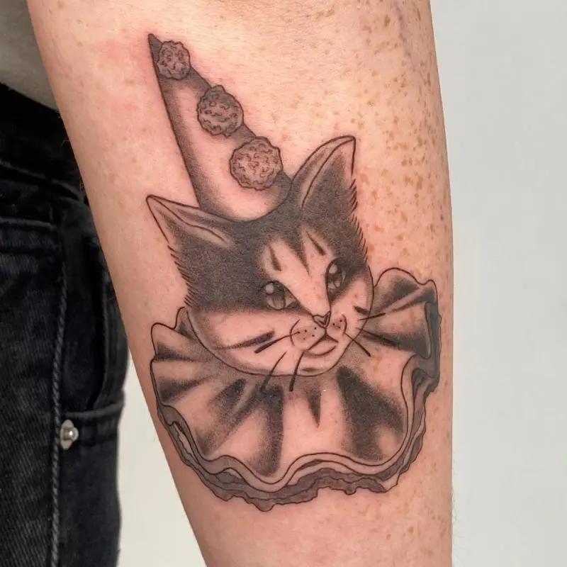 a tattoo of a cat on a person's arm