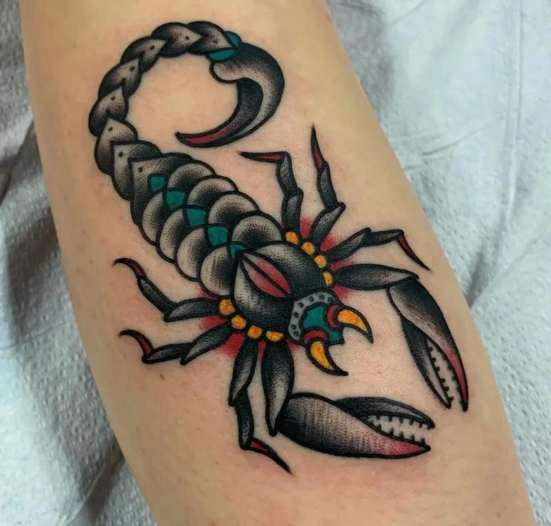 a tattoo of a scorpion on a person's arm