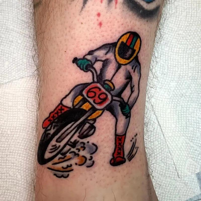 a man driving a motorcycle tattoo