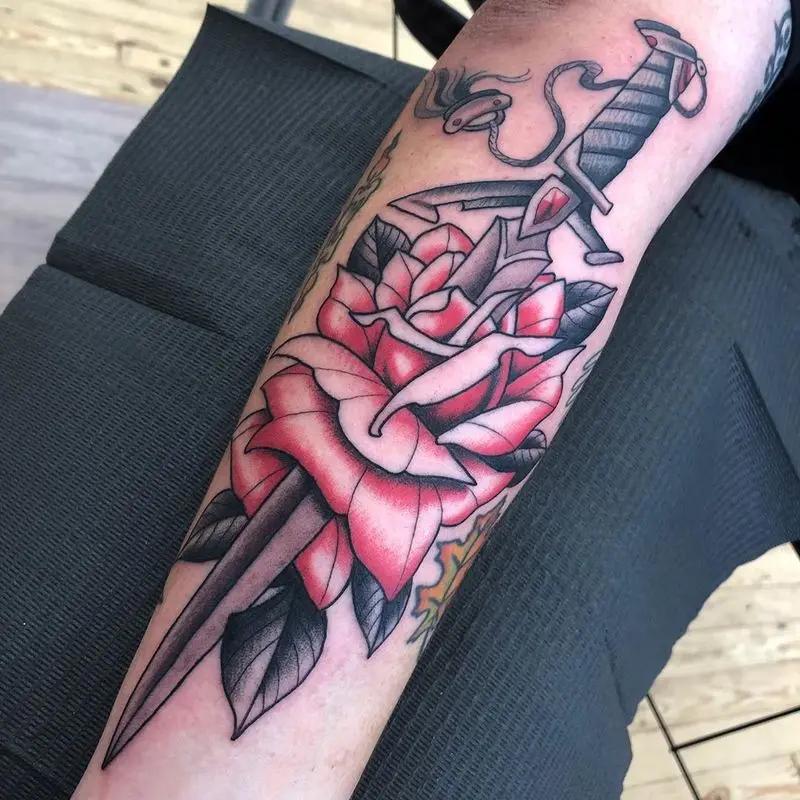 a rose tattoo at the forearm