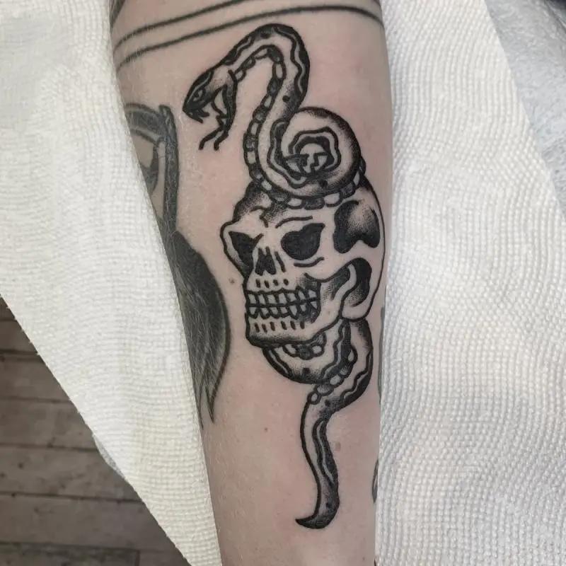 a skull and snake tattoo