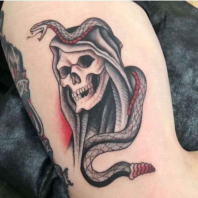 a skull tattoo with snake